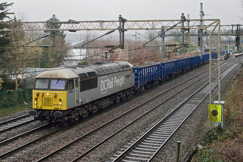 56091, 09.15 Wembley Reception Sidings-Chaddesden Sidings (6Z46, 27E), Apsley 
 I had been tracking the slow and painful progress of the 6Z46 09.15 Wembley to Chaddesden spoil train thinking that I would have to miss it due to my appointment to collect my new car. However, it made up some time so I waited and was rewarded with it passing Apsley just a little late with 56091 'Driver Wayne Gaskell The Godfather' leading. This particular Class 56 is now over forty years old but is still in frontline service now with DC Railfreight, one of three members of the class that they operate. 
 Keywords: 56091 09.15 Wembley Reception Sidings-Chaddesden Sidings 6Z46 Apsley 'Driver Wayne Gaskell The Godfather'