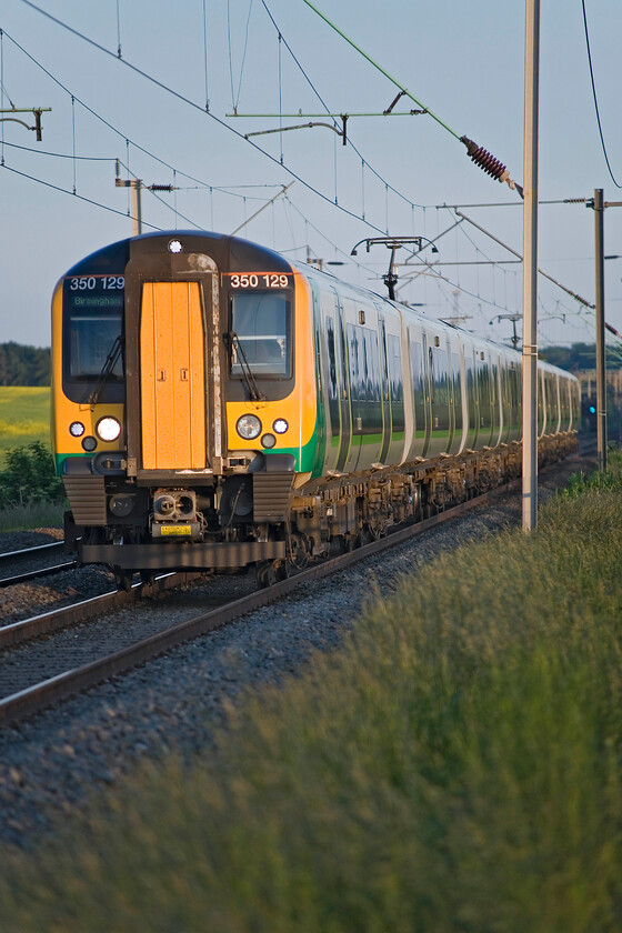 350129, LM 19.46 London Euston-Birmingham New Street (1Y79), Milton Malsor SP740553 
 It's now just fifteen minutes before 21.00 so this is the last picture taken on this summer solstice evening before heading for home. A pair of London Midland Desiros approach Northampton past Milton Malsor led by 350129 working the 19.46 Euston to Birmingham New Street service. Another example of an image with superb late evening summer lighting; how I long for this come mid-January! 
 Keywords: 350129 19.46 London Euston-Birmingham New Street 1Y79 Milton Malsor SP740553 London Midland desiro