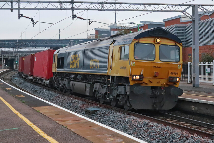 66701, 12.18 London Gateway-Hams Hall (4M47, 20L), Wolverton station 
 GBRf's 66701 passes through Wolverton station with the 12.18 London Gateway to Hams Hall 4M07 service. Now twenty-two years old 66701 has carried two names in its life, for nearly four years it was 'Railtrack National Logistics' and then for seven years it was 'Whitemoor'. After this train had passed, Andy and I walked back to our respective cars and went on our separate ways, Andy to work and me home! 
 Keywords: 66701 12.18 London Gateway-Hams Hall 4M47 Wolverton station GBRf GB Railfreight