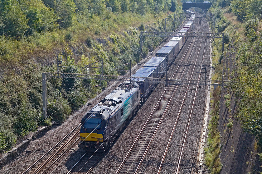 88003, 08.02 Tilbury FLT-DIRFT (4M07, RT), Roade cutting 
 Taken against the September sunshine 88003 'Genesis' leads the 08.02 Tilbury FLT to Daventry 'Tesco Express' through Roade cutting. This service and the balancing 4L48 are almost exclusively hauled by one of DRS' Class 88 now. 
 Keywords: 88003 08.02 Tilbury FLT-DIRFT 4M07 Roade cutting DRS Direct Rail Services Genesis