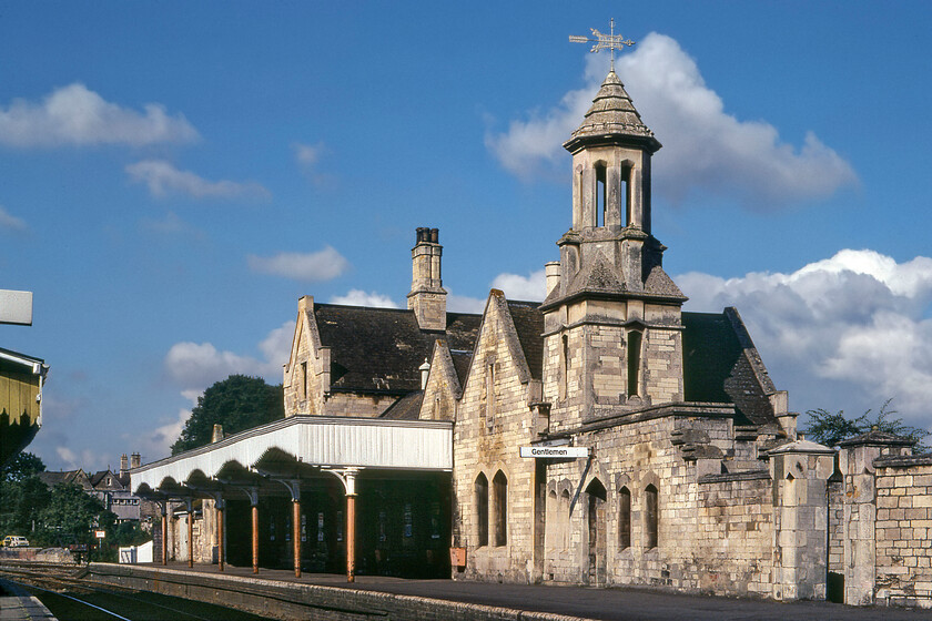 Stamford station from east 
 Stamford station from the eastern end looks superb in the early morning summer sun. We spent a little time at the delightful station that was, being a Sunday morning, particularly quiet. The superb station building, built in a mock Tudor style, was designed by the celebrated architect Sancton Wood (1814-1886). It is said that he took his inspiration from the nearby Burghley House of horse trial fame. Notice Graham's trusty Austin 1100 parked up at the far western end of the station high on a loading ramp! 
 Keywords: Stamford station from east