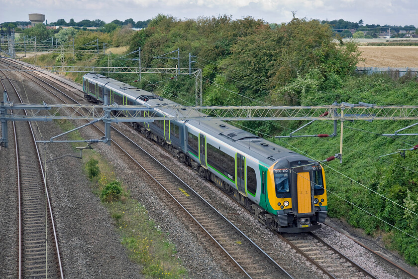 350110, LM 13.12 Northampton-London Euston (cancelled from Birmingham New Street), (1W14), Victoria bridge 
 Following issues in the Birmingham area earlier in the morning, a number of London Midland services were subject to delay, cancellations or alteration. One example affected was this one being worked by 350110 that should have originated from Birmingham New Street. Instead, it was re-timetabled to become the 13.12 Northampton to Euston. Notice this set has its centre two coaches painted in a slightly different livery that contains a 'Project 110' vinyl that was applied earlier this year. 
 Keywords: 350110 13.12 Northampton-London Euston 1W14 Victoria bridge London Midland Desiro Project 110