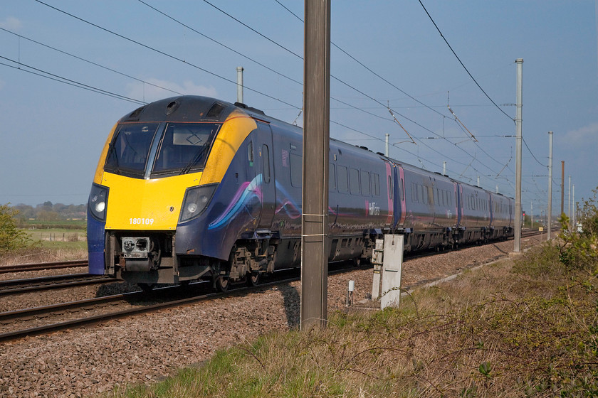 180109, HT 08.23 Hull-London King`s Cross (1A92, 1E), Claypole Barnby Lane crossing 
 One of Hull Train's notoriously unreliable class 180s pass Claypole's Barnby Lane level crossing with the 08.23 Hull to King's Cross. Hull Trains has been struggling with availability of these technically advanced units for a while now to the point here they have had to hire in redundant HST sets to cover whilst repairs and modifications take place. How ironic that forty year old trains are proving to be more reliable than units less than half their age! 
 Keywords: 180109 08.23 Hull-London King`s Cross 1A92 Claypole Barnby Lane crossing