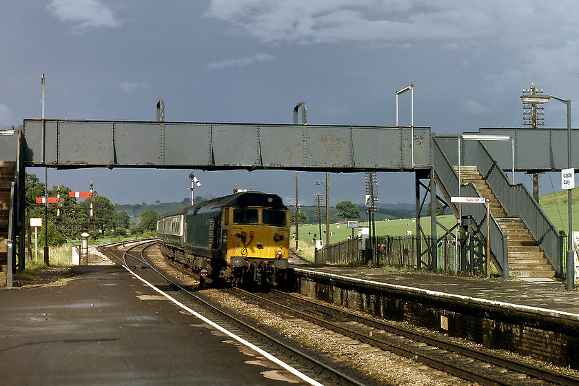 50023, 16.30 London Paddington-Penzance, Castle Cary station 
 50023 'Howe' thunders through Castle Cary at full line speed having descended from Brewham Summit with the (SuO) 16.30 London Paddington to Penzance working. The dramatic sky behind had passed over Castle Cary a short time before and had dropped some spectacularly heavy rain! It's a shame that I had not quite got the locomotive positioned a little later so that the front was not in the shadow of the footbridge. 50023 made it into preservation but was cut up for spares at Barrow Hill in 2004. 
 Keywords: 50023 16.30 London Paddington-Penzance Castle Cary station