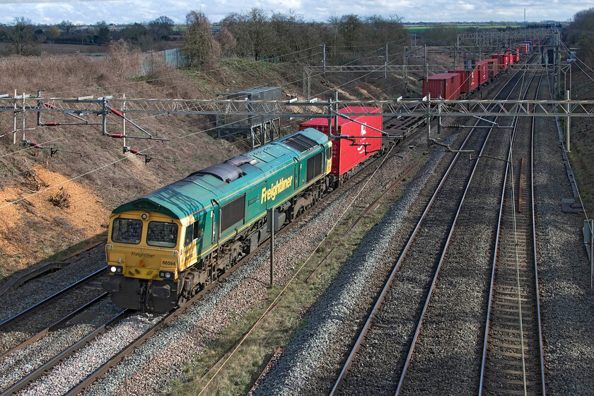 66594, 09.27 Southampton MCT-Garston (4M58, 40E), Victoria bridge 
 In some lovely spring sunshine, 66594 NYK Spirit of Kyoto' leads the daily Freightliner 4M58 09.27 Southampton MCT to Garston service. The view at this, one of my most favoured, spots just south of Roade in Northamptonshire has really been opened up in recent weeks with a concerted bout of tree clearance. Whist I understand the reasoning behind it from an operational perspective as a railway photographer I really appreciate it! 
 Keywords: 66594 09.27 Southampton MCT-Garston 4M58 Victoria bridge Freightliner NYK Spirit of Kyoto