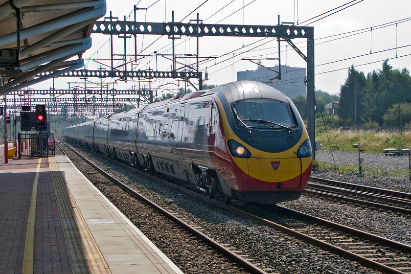 390123, VT 09.34 London Euston-Glasgow Central (9S55), Rugby station 
 Virgin's 390123 takes the centre road through Rugby at full line speed working the 09.34 Euston to Glasgow Central 9S55 service. I have broken all the photographic rules here but I like taking such risks! 
 Keywords: 390123 09.34 London Euston-Glasgow Central 9S55 Rugby station Virgin Pendolino