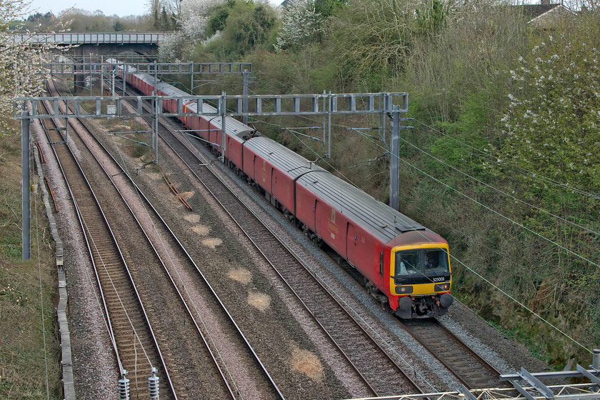 325001, 325013 & Clas 325, 16.21 Willesden PRDC-Sheildmuir (1S96, 3E), Roade Hyde Road bridge 
 Still feeling the effects of a prolonged closure of the up and down slow lines just south of Roade, the 1S96 16.21 Willesden to Shieldmuir Royal Mail train is on the down fast passing Roade's Hyde Road bridge. Today, the train is being worked by 325001 and 325013 but I was unable to identify the final unit of the consist. 
 Keywords: 325001 325013 Class 325 16.21 Willesden PRDC-Sheildmuir 1S96 Roade Hyde Road bridge Royal Mail