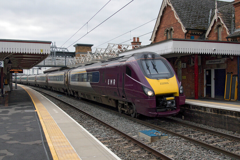 222005, EM 11.32 London St. Pancras-Sheffield (1F32, RT), Wellingborough station 
 EMR Meridian 222005 passes through Wellingborough station working the 11.32 St. Pancras to Sheffield service. This purple EMR paint scheme will be the final one that these units will carry while in operation on the MML before coming off-lease next year to be replaced by new-build IET bi-mode trains. Notice the recently reinstated reproduction Midland Railway canopies above the Meridian. 
 Keywords: 222005 11.32 London St. Pancras-Sheffield 1F32 Wellingborough station EMR Meridian