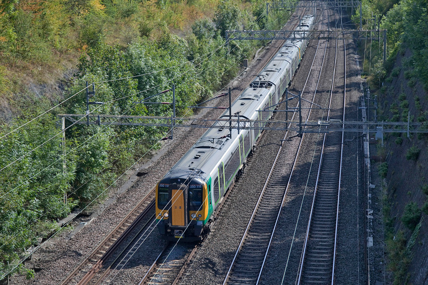 350118 & 350114, LN 12.31 London Euston-Birmingham New Street (1W53, 9L), Roade cutting 
 Two of the earlier batch of class 350 Desiros, introduced on this route new in 2005, where they have worked ever since, pass through Roade cutting. 350118 and 350114 work the 12.31 Euston to Birmingham New Street, a service that arrived some nine minutes late due to delays in the Coventry area. 
 Keywords: 350118 350114 12.31 London Euston-Birmingham New Street 1W53 Roade cutting