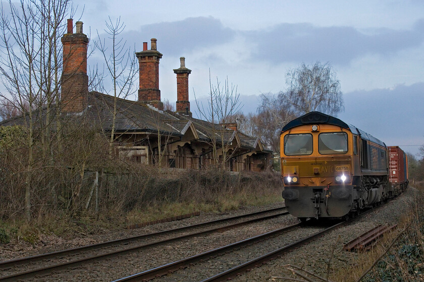 66758, 10.28 Felixstowe North-Hams Hall (4M29, 7E), Brooksby level crossing 
 Just as we arrived at Brooksby level crossing between Melton Mowbray and Syston Junction the barriers went down giving me just enough time to set my camera up for the 10.28 Felixstowe to Hams Hall Freightliner. 66758 'The Pavior' is captured a little early in a deliberate move to include the superb former station building to the left of the scene; what a place to live! 
 Keywords: 66758 10.28 Felixstowe North-Hams Hall 4M29 Brooksby level crossing GBRf The Pavior