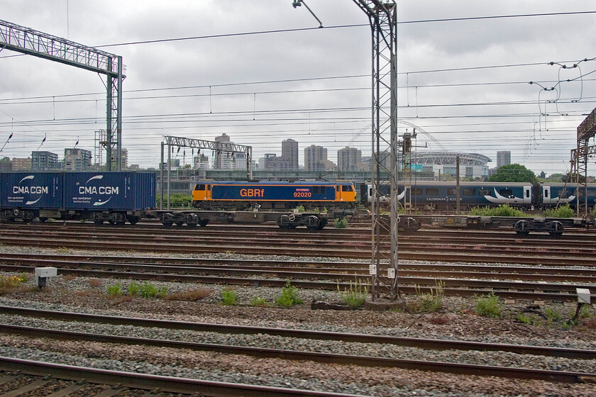 90020, stabled sleeper, Wembley Yard 
 GBRf's 92020 'Billy Stirling' is seen in Wembley Yard at the head of what would have been one of two Caledonian Sleeper trains that arrived in Euston earlier in the morning from Scotland. The Class 92 will have towed the empty stock from Euston back to Wembley Yard for it to be serviced and readied for one of the coming evening's return sleepers. 
 Keywords: 90020 stabled sleeper Wembley Yard Billy Stirling