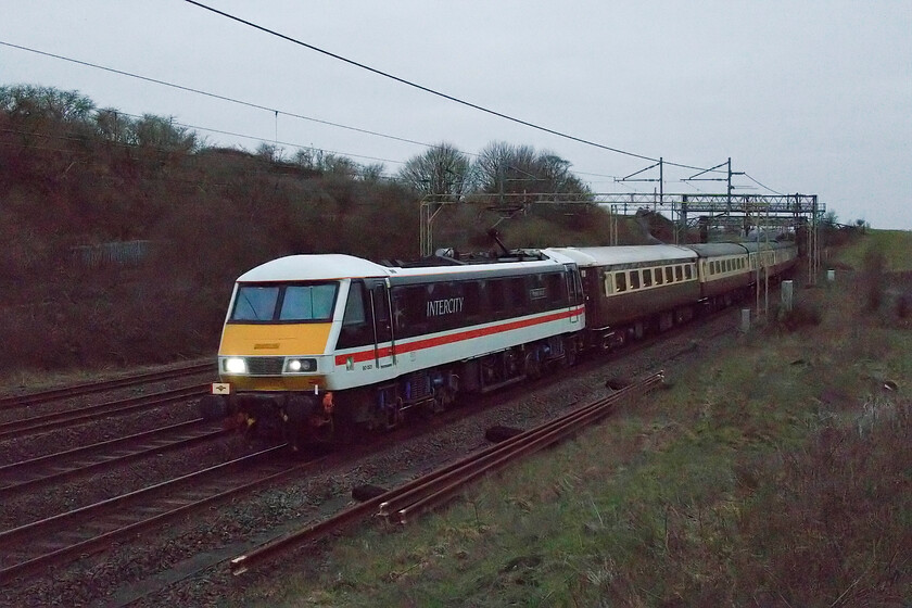 90001, outward leg of 'The Golden Arrow', 05.22 Birmingham International-Canterbury West (1Z12, 12E), Old Linslade 
 In what is probably not even half light at 07.01 LSL's 90001 Wolf of Badenoch passes Old Linslade just north of Leighton Buzzard. I was delighted that the AC electric was leading instead of the advertised Class 47 as if this had been the case it would have probably been indiscernible from the background. The camera has really had its work cut out, aided by some Photoshop jiggery-pokery, to capture the outward leg of 'The Golden Arrow' charter that left Birmingham International at 05.22 and was heading to Canterbury West with steam in the form of 34046 'Braunton' taking over in Acton Yard. 
 Keywords: 90001, outward leg of 'The Golden Arrow', 05.22 Birmingham International-Canterbury West (1Z12, 12E), Old Linslade