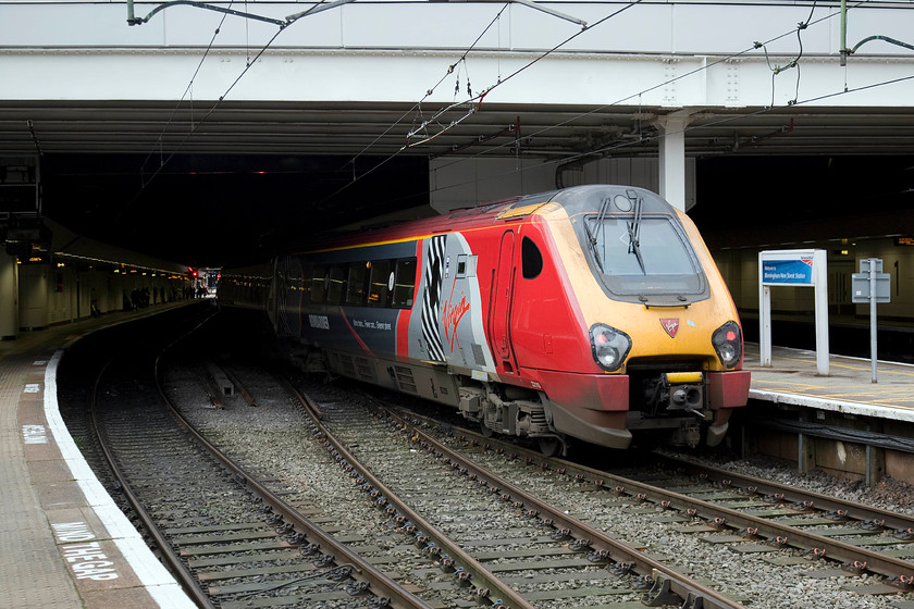 221115, VT 13.20 Birmingham New Street-Preston (2S65), Birmingham New Street station 
 The rear end of 221115 'Polmadie Depot' sits in the grey daylight at Birmingham New Street as it waits to leave with the 13.20 to Preston. Can somebody explain the sense of running a diesel powered unit all the way under the wires on this 103 mile journey? 
 Keywords: 221115 13.20 Birmingham New Street-Preston 2S65 Birmingham New Street station