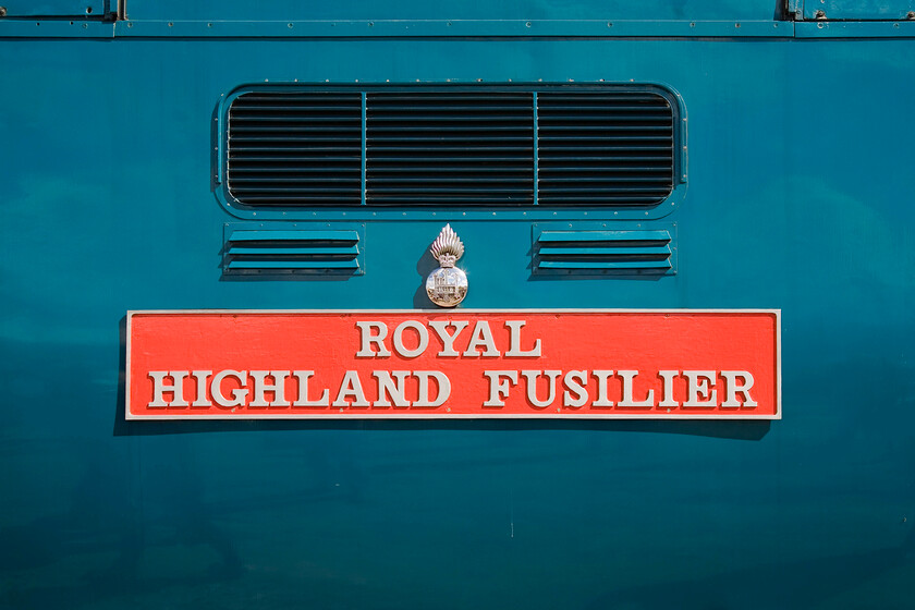 Nameplate, 55019, on display, Mallard 75 celebrations, Grantham Yard 
 Something is amiss here with the nameplate attached to the side of 55019 'Royal Highland Fusilier'. Close examination reveals that it is sitting proud of the Deltic's bodywork suggesting that it is some kind of copy. Can anybody advise what has occurred here, please. The locomotive was part of a display of locomotives and various other things in a small yard next to Grantham station as part of the Mallard 75 celebrations. 
 Keywords: Royal Highland Fusilier Nameplate 55019 Mallard 75 celebrations Grantham Yard