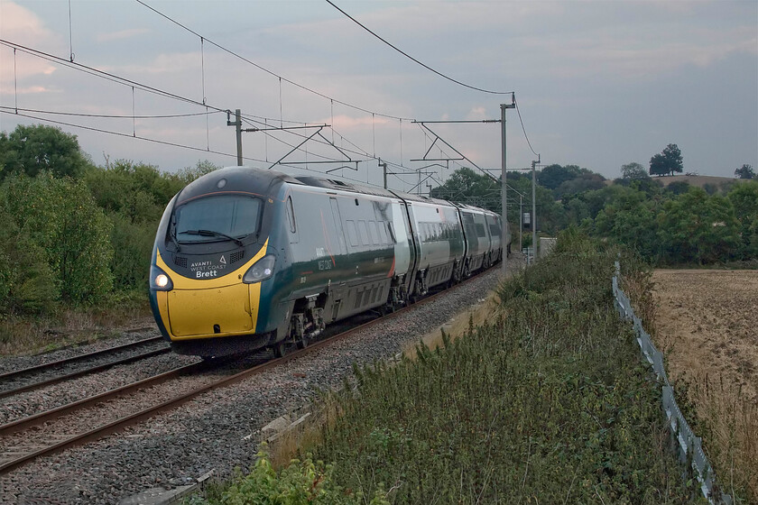 390129, VT 17.39 London Euston-Glasgow Central (9S96, 2L), Bugbrooke footbridge 
 In atrocious early evening light that almost persuaded me to head for home rather than stop off returning from work 390129 'City of Stoke-on-Trent' passes Bugbrooke on the Weedon loop that avoids passing through Northampton. The Pendolino, working the 17.39 Euston to Glasgow, was one of just two that I saw in thirty minutes by the side of the WCML and this was on a Friday evening! This is the actual effect that Avanti's appalling slashing of services has had on the passage of trains. I had such high hopes for the company when they took over from Virgin in December 2019 but they have proved to be a very poor operator. With their managing director having now resigned with immediate effect it is now time that, like a number of other operators, their franchise is stipped and that the state takes over which is as the railways should be run. 
 Keywords: 390129 17.39 London Euston-Glasgow Central 9S96 Bugbrooke footbridge Avanti Wast Coast Pendolino City of Stoke-on-Trent