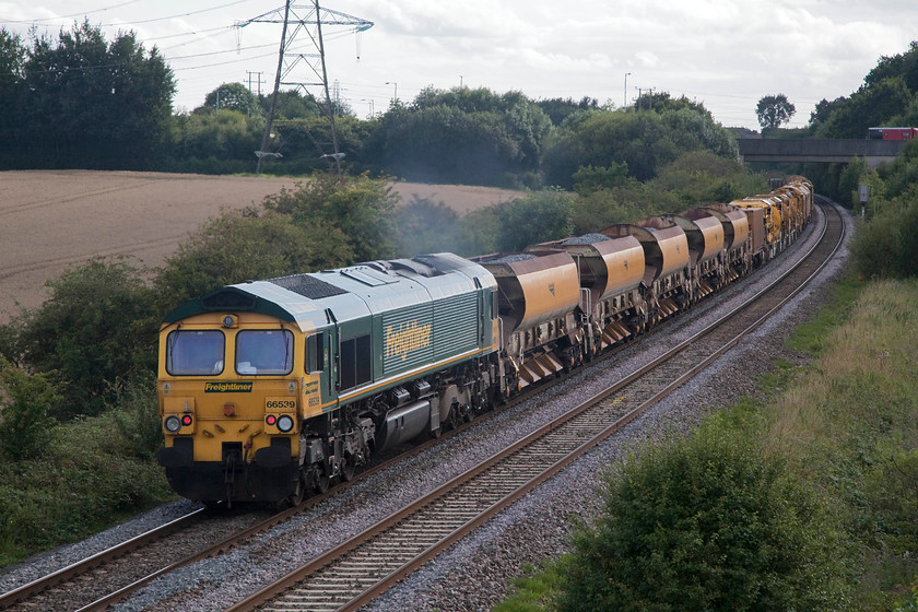 66539, 13.48 Twyford West-Fairwater Yard HOBC (6C73 ), Berkley ST802494 
 66539 appears to be doing all the work at the back of the 13.48 Twyford to Taunton Fairwater Yard HOBC train. 66511 is up at the front of the train and has already passed under the A361 bridge near to Berkley and will be in view at Frome's Clink Road Junction. 
 Keywords: 66539 13.48 Twyford West-Fairwater Yard HBOC (6C73 ) Berkley ST802494