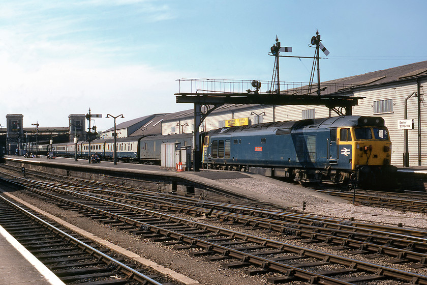 50012, 10.05 Paignton-London Paddington, Exeter St. David`s station 
 50012 'Benbow' pauses at Exeter St. David's leading the 10.05 Paignton to Paddington express. The consist is interesting in that it has both a General Utility Van (GUV) and a Mk.I Brake Gangwayed (BG) marshalled behind the locomotive. The fourth coach in the consist is a Mk.I catering vehicle with the rest of the train being Mk.IIf air-conditioned stock. You just don't get trains like this today with this service being formed by a five-car Class 800 unit.

There is an audio recording of this event on my youtube channel, see... https://youtu.be/6llZcsXby4w 
 Keywords: 50012 Benbow 10.05 Paignton-London Paddington Exeter St. David's station