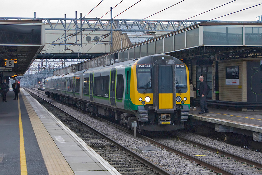 350241, LM 12.02 Crewe-London Euston (1U30), Milton Keynes station 
 On a dismal December afternoon at Milton Keynes, 350241 pauses with the 12.02 Crewe to London Euston London Midland service. This train has worked fast from Rugby missing out the Northampton loop but will now run on the up slow to London with one stop at Watford Junction. 
 Keywords: 350241 LM 12.02 Crewe-London Euston 1U30 Milton Keynes station London Midland Desiro