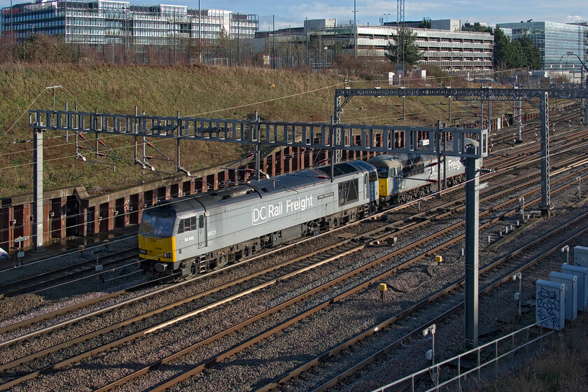 60046 & 56091, 11.30 Willesden DC Rail Sidings-Leicester LIP (0Z56, 6E), Loughton Redway bridge, Milton Keynes 
 With the skyline of Milton Keynes looking reassuringly familiar 60046 'William Wilberforce' leads 56091 'Driver Wayne Gaskell' as the 0Z56 11.30 Willesden to Leicester LIP light engine move. With the future of the remaining Class 60s looking pretty bleak now with DB standing their examples down DCR remains the only operator having four in service. 
 Keywords: 60046 56091 11.30 Willesden DC Rail Sidings-Leicester LIP 0Z56 Loughton Redway bridge Milton Keynes DCR DC Rail Freight William Wilberforce Driver Wayne Gaskell