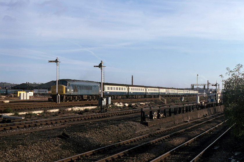 45138, 13.25 London St. Pancras-Nottingham, Brent yard 
 I have not quite managed to place 45138 correctly positioning it behind one of Brent yard's signal posts, in this case, a distant operated by Cricklewood signal box. The Peak (formally D92) is leading the 13.25 St. Pancras to Nottingham. Notice Cricklewood depot in the background with a couple of Peaks on-shed along with a class 127 DMU. 
 Keywords: 45138 13.25 London St. Pancras-Nottingham Brent yard