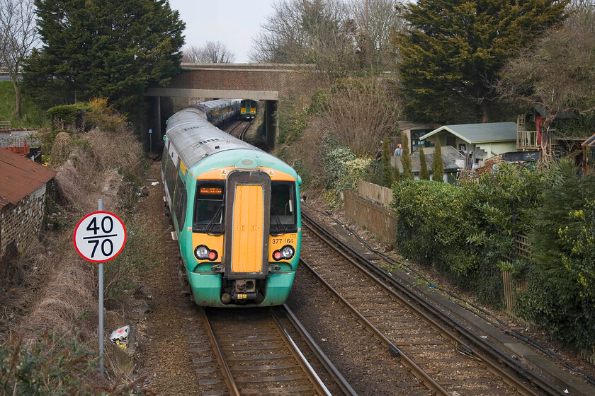 377164 & 377162, SN 15.56 Bognor Regis-London Victoria & 313213, SN 15.53 Barnham-Bognor Regis, London Road footbridge, Bognor Regis 
 Just to the north of Bogor Regis station is a footbridge adjacent to the superb signal box. The bridge provides a good view of the station throat and is a great place to observe railway operations. 377164 and 377162 have just left the station working the 15.56 service to Victoria as 313213 approaches with the 15.43 shuttle service from Barnham. 
 Keywords: 377164 377162 15.56 Bognor Regis-London Victoria 313213 15.53 Barnham-Bognor Regis London Road footbridge Bognor Regis