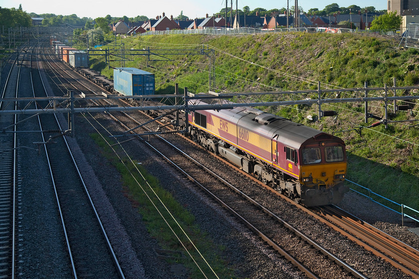 66110, 13.15 Trafford Park-London Gateway (4L56, 125L), Ashton Road bridge 
 66110 leads the 13.15 Trafford Park to London Gateway Freightliner past Roade about to pass under Ashton Road bridge. It is quite extraordinary that despite not being owned and operated by EWS since January 2009 that it still wears its complete livery and branding. I do not understand why DB Schenker and DB Cargo UK have not even applied any branding in the last eleven years? 
 Keywords: 66110 13.15 Trafford Park-London Gateway 4L56 Ashton Road bridge