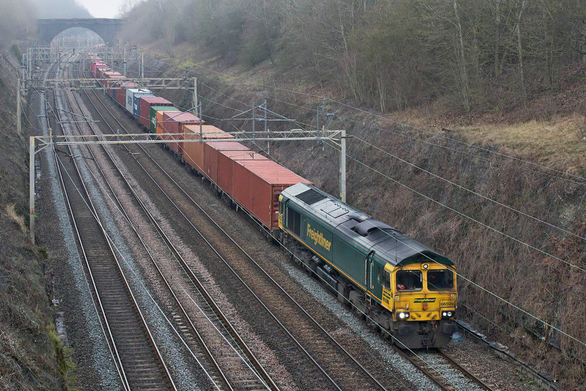 66599, 12.16 Lawley Street-London Gateway (4L46, 4L), Hyde Road bridge 
 I have observed many freight workings passing here through Roade cutting over the years but not one going quite as slowly as this! Watching its progress on OpenTrainTimes I was wondering if there was a software problem with the app. as it was taking an age for the 12.16 Lawley Street to London Gateway to progress from signal to signal. Eventually, it appeared around the corner in the distance making very laboured progress that I would estimate to be about twenty mph being led by Freightliner's 66599. The train was long, fully loaded and there is a steady rising gradient from Northampton but even so, a Class 66 should not make quite such a meal of it. 
 Keywords: 66599 12.16 Lawley Street-London Gateway 4L46 Hyde Road bridge Freightliner