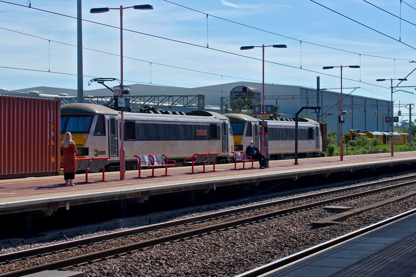 90008 & 90012, 06.15 Trafford Park-Felixstowe North (4L97, 3L), Rugby station 
 The 4L97 06.15 Trafford Park to Felixstowe Freightliner service came to a halt at Rugby station just as Andy and I were about to get our next onward train. It is being led by a pair of the former Greater Anglia Class 90s now demoted from top link passenger work to freight duties. Still wearing its plates 90012 'The East Anglian' is second with 90012 leading. The Class 90s taken on by Freightliner at their Crewe Basford Hall base have completely ousted the veteran Class 86s that are now stored in various conditions. I have photographed both of these locomotives at Norwich in past years, for example..... https://www.ontheupfast.com/p/21936chg/29952522404/x90012-15-30-norwich-london-liverpool and...... https://www.ontheupfast.com/p/21936chg/25040128604/x90008-15-00-norwich-london-liverpool 
 Keywords: 90008 90012 06.15 Trafford Park-Felixstowe North 4L97 Rugby station The East Anglian