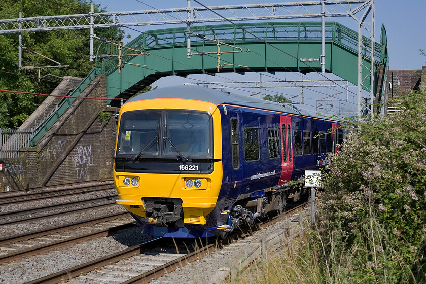 166221, 09.23 Wolverton Sidings-Reading Traincare Depot (5V65), Bradwell SP831391 
 An unusual visitor to the WCML is a First Great Western turbo unit in the form of 166221. It has just left Wolverton Works a short distance north of this location at Bradwell in Milton Keynes heading back to its home depot at Reading. 
 Keywords: 166221 09.23 Wolverton Sidings-Reading Traincare Depot 5V65 Bradwell SP831391 Turbostar First Great Western