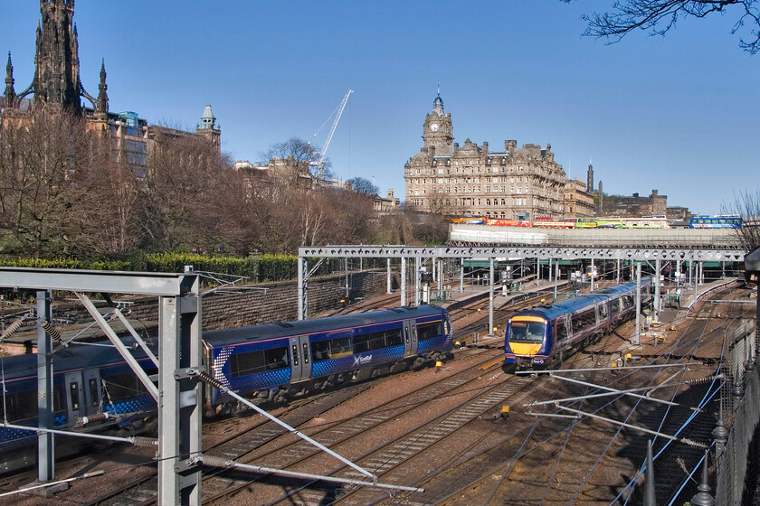 170453, SR 12.53 Inverness-Edinburgh Waverley & 170420, unidentified working into Edinburgh Waverley, Edinburgh Waverley station from The Mound 
 A wider angle photograph of the western throat of Edinburgh Waverley station not only shows the station but also the impressive former North British Station Hotel and to the left the Scott Monument (as in Sir Walter Scott). Down below 170453 winds into the station at the end of its journey as the 12.53 from Inverness. To its right 170420 leaves working an unidentified working. 
 Keywords: 170453 12.53 Inverness-Edinburgh Waverley 170420, unidentified working into Edinburgh Waverley Edinburgh Waverley station from The Mound ScotRail