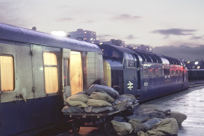 55022, 16.30 Hull-London KIng's Cross (1A28), Hull station 
 An everyday scene of the era at Hull station showing the mail being loaded into a BG (Brake Ganwayed) Mk. I coach at the front of the 1A28 16.30 Hull to London Kings Cross. Deltic 55022 Royal Scots Grey will lead the train. Gone are the days of bags of mail being loaded and unloaded from trains with them all going by road now. However, there is continued talk of mail returning to rail and with ever-increasing environmental and climate targets to be met this really makes sense!

There is an audio recording of this event on my Youtube channel, see..... https://youtu.be/KeTVheQqth8 
 Keywords: 55022 16.30 Hull-London KIng's Cross 1A28 Hull station