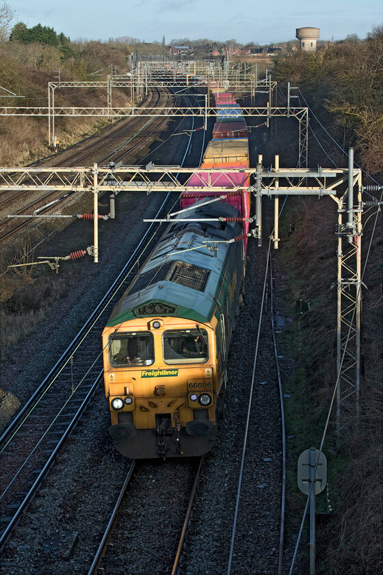 66556, 03.25 Garston-London Gateway (4L52, 10L), Victoria bridge 
 I gambled on the early morning sun just being high enough to illuminate the 03.25 Garston to London Gateway 4L52 Freightliner at Victoria bridge just south of Roade and I was just about correct to do so with most of the front end, the side and the roof in the light! 66556 leads the train that was a lot more heavily loaded than I have seen of late; perhaps trade is picking up again? 
 Keywords: 66556 03.25 Garston-London Gateway 4L52 Victoria bridge Freightliner