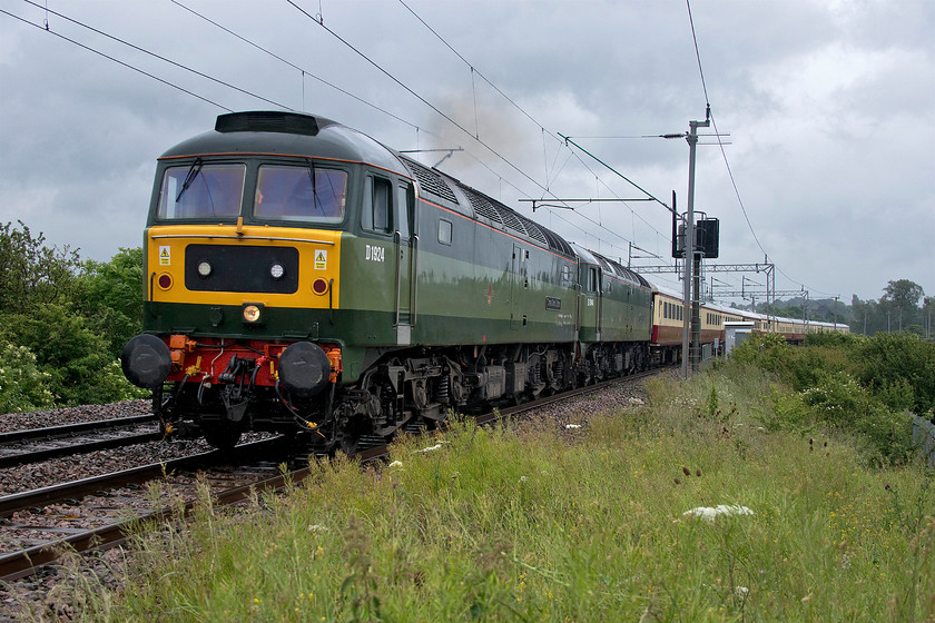 D1924 & D1944, outward leg of The Crewe Open Day and The Medieval Chester, 08.26 London-Euston Crewe & Medieval Chester (1Z40), Wilson`s crossing 
 Within ten minutes of leaving Euston D1944 (47501) 'Craftsman' that is the second locomotive here, failed and was stopped at Willesden. UK Railtours 1Z40 trip to Crewe was taking taking people to the open day being held at the Crewe Diesel Depot HQ of Locomotive Services Ltd. For those not interested in that, the train then continued on to Chester for a few hours before returning. Within an hour of the failure, D1924 (47810) 'Crewe Diesel Depot' had been removed from the rear of the train and attached to the front. Now double-headed, the train is seen in the pouring rain leaving Northampton past Wilson's Crossing forty-five minutes down with it eventually arriving at Crewe and later Chester some twenty-two minutes adrift. 
 Keywords: D1924 D1944 The Crewe Open Day The Medieval Chester 08.26 London-Euston Crewe & Medieval Chester 1Z40 Wilson`s crossing