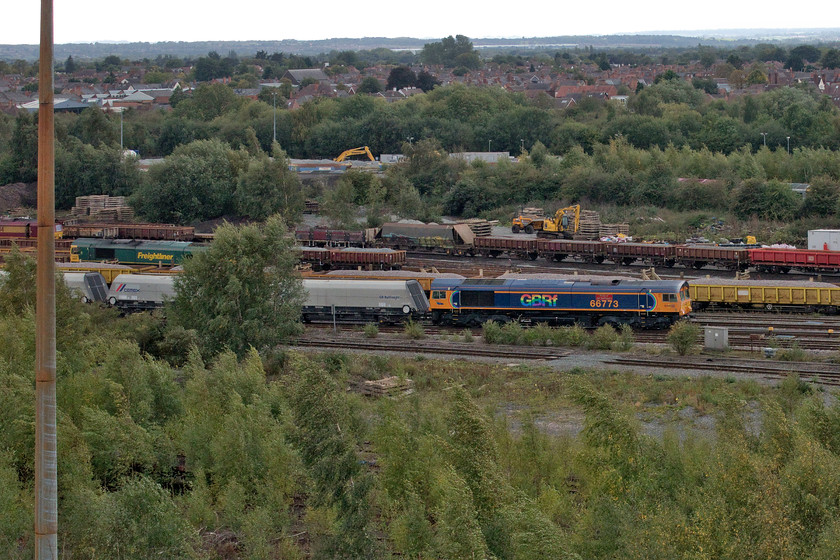 66773, 10.35 Bletchley Cemex-Peak Forest (6H10, 2L), Toton yard 
 Taken from the famous Toton bank 66773 'Pride of GB Railfreight' is seen entering the yard complex leading the 10.35 Bletchley to Peak Forest empty stone train. The train came to a halt and after a brief layover where it appeared that a crew change took place, it headed off north again up the Erewash Valley. This is my first photograph of this particular Class 66 since it was adorned with a PRIDE version of GBRf's logo and the nameplates attached. 
 Keywords: 66773 10.35 Bletchley Cemex-Peak Forest 6H10 Toton yard Pride of GB Railfreight GBRf