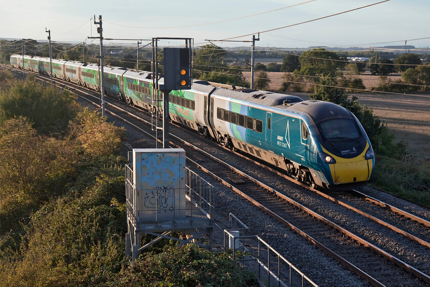 390121, VT 16.47 Liverpool Lime Street-London Euston (1A58, 2E), Milton crossing 
 The unique liveried 390121 'Opportunity' has evaded my camera since it received its unique livery associated with last November's (2021) Cop26 meeting in Glasgow. It is seen catching the evening sunshine working the 1A58 16.47 Liverpool to Euston Avanti service past Milton crossing in Northamptonshire. 
 Keywords: 390121 16.47 Liverpool Lime Street-London Euston 1A58 Milton crossing Opportunity