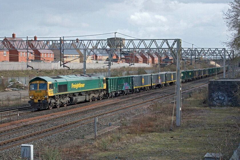 66610, 13.20 Willesden up & down relief-Barrow Hill (6H50, 2L @ Chinley North), site of Roade station 
 The 6H50 13.20 Willesden to Barrow Hill, composed of a number of MWA wagons, passes the site of Roade station hauled by 66610. This train did not make it as far as Barrow Hill disappearing from RTT at Chinley making me wonder if it ended up at Peak Forest. The heavily graffitied MWA wagons are relatively new being converted from redundant HHA coal vehicles. 
 Keywords: 66610 13.20 Willesden up & down relief-Barrow Hill 6H50 Chinley North site of Roade station Freightliner