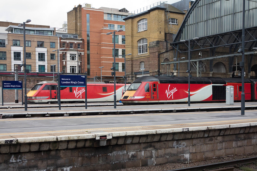 91113, GR 13.00 London KIng`s Cross-Edinburgh (1S18, 20L) & 43295, GR 12.00 London Kings Cross-Inverness (1S16, 1E), London King`s Cross station 
 Two Virgin East Coast workings wait at King's Cross. 91113 has an hour to go before its 13.00 departure to Edinburgh. Meanwhile, 43295 is about ready to start its journey north forming the 12.00 to Inverness, 'The Highland Chieftain'. On this day, having covered the 581 miles, this 40-year-old HST managed to arrive 1 minute early, pretty good in anybody's book I think! I stood in a very similar spot some thirty-seven years earlier and took a photograph but the subject matter back then was a little more interesting, see.... https://www.ontheupfast.com/p/21936chg/30022860827/x8-55017-12-34-hull-london-king-s! 
 Keywords: 91113 1S18 43295 1S16 London King's Cross station