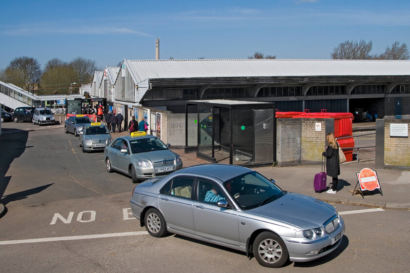 Frontage, Northampton station from car park 
 The station frontage at Northampton is seen from the recently opened double-decker car park. A strict one-way system is in operation at present as the front car park is closed off due to archaeological excavations prior to the building of the new station building. The 'three cowsheds' (as dubbed by critics) that make up the present station are seen clearly in this view. 
 Keywords: Frontage Northampton station from car park