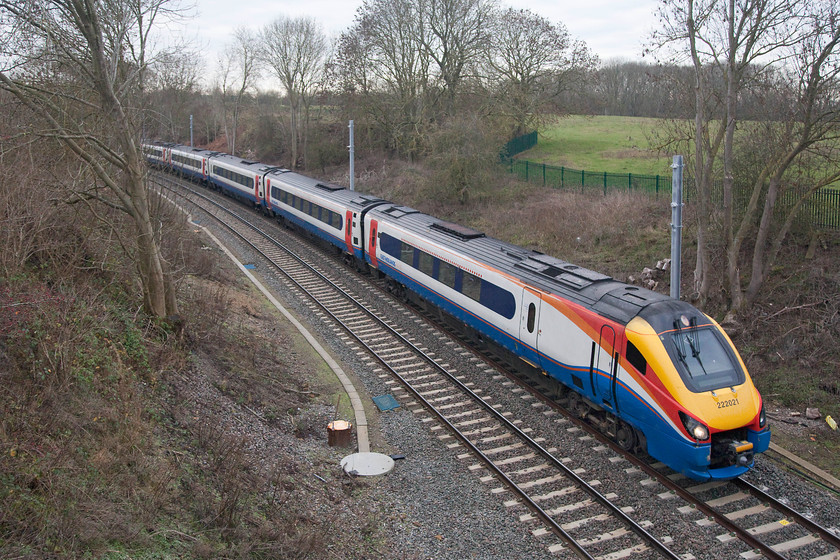 222021, 09.47 London St. Pancras-Corby (1M12, 1E), Glendon Iron Coys bridge SP854823 
 222021 works the 09.47 London St. Pancras to Corby under the strangely named Glendon Iron Coys bridge. This is just beyond where the Corby/Manton Junction line parts company from the Midland Mainline that is in a cutting below the trees seen through the gap in the very background. Notice the recently installed electrification masts, a portents of things to come. It won't be long before the Meridians are ousted from this line in favour of some new electric units. 
 Keywords: 222021 09.47 London St. Pancras-Corby 1M12 Glendon Iron Coys bridge SP854823