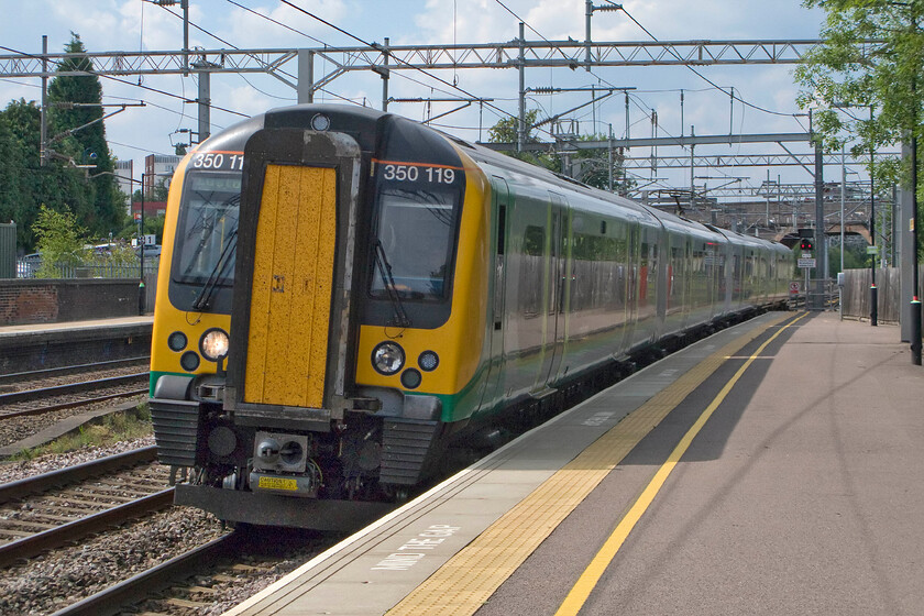 350119, LM 14.02 Crewe-London Euston (1U34), Lichfield Trent Valley station 
 After a great day in the Lichfield area, my first train home to Northampton arrives at Trent valley station. My bike and I took 350119 working the 14.02 Crewe to Euston as far as Rugby. As can be seen in this photograph in typical British summer fashion the clear blue skies with high temperatures of the morning have now given way to a stormy looking sky. 
 Keywords: 350119 14.02 Crewe-London Euston 1U34 Lichfield Trent Valley station