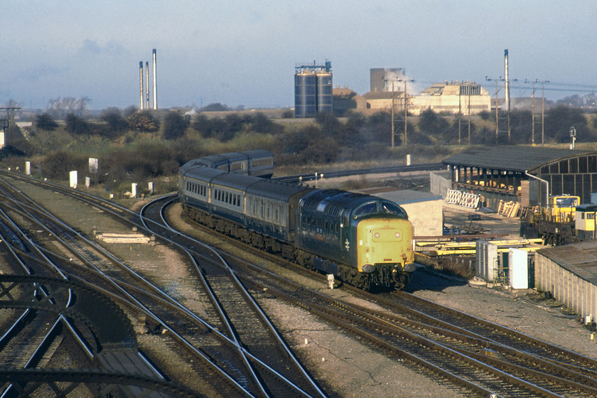 55016, 12.34 Hull-London King's Cross (1A18), Doncaster North Junction 
 Standing on Doncaster's North Bridge Road reveals the ECML heading off to the left with the line from Goole and ultimately Hull joining from the right. 55016 'Gordon Highlander' is seen catching the winter sunshine leading the 1A18 12.34 Hull to King's Cross service. To the right is PW depot that is rail linked, as is the case today but I suspect there will be no wooden level crossing gates leaning against the building now as is seen in this photograph. 
 Keywords: 55016 12.34 Hull-London King's Cross 1A18 Doncaster North Junction Gordon Highlander