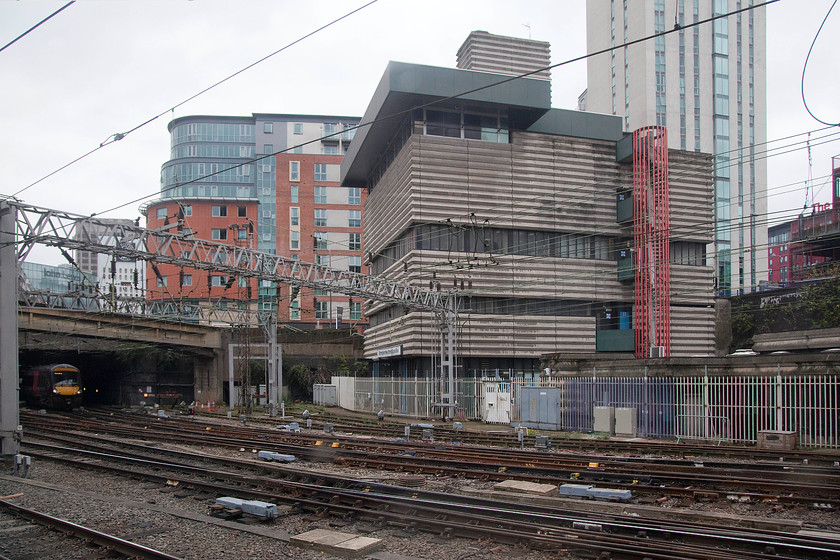 Birmingham New Street PSB (BR, 1966) 
 Birmingham New Street PSB is seen from the train as it enters the station. The corrugated concrete Brutalist structure was Designed by Bicknell & Hamilton for BR (WR) in 1965. As the Birmingham Post wrote 'it's unapologetically bunker-like structure is an honest expression of its utilitarian function'. It stands five storeys high above track level giving no clue of the hive of activity that exists within its four walls apart from a small sign above the first floor. It is grade II listed so this controversial structure is likely to remain intact even after it has been rendered redundant when the West Midlands signalling centre opens. 
 Keywords: Birmingham New Street PSB