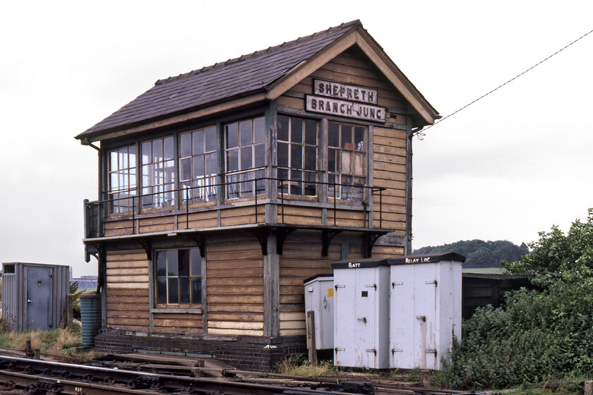 Shepreth Branch Junction signal box (GER, 1893) 
 A classic Great Eastern Railway Type 7 box at Shepreth Junction was a superb original condition structure when photographed here in 1981. It still retains its old Eastern Region green and cream colour scheme, something it did right up until its closure in February 1983. The box was fitted with a twenty-lever McKenzie & Holland frame and controlled the junction where the Great Eastern route to King's Cross via Royston and Baldock diverged from the Liverpool Street route via Bishop's Stortford. Notice the rather austere personal needs addition to the left of the box and the large building between the two that is the world-famous Papworth and Addenbrooke's Hospital complex. 
 Keywords: Shepreth Branch Junction GER Great eastern Railway