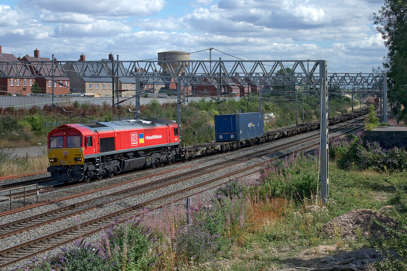 66099, 12.19 Tilbury-Trafford Park (4M85, 21E), site of Roade station 
 If looking at this photograph brings on a sense of deja-vu then you are right to pause and think! A little short of two weeks previously I photographed the same locomotive in exactly the same spot on leading the same working, see.... https://www.ontheupfast.com/p/21936chg/30030343409/x66099-12-19-tilbury-trafford-park! 66099 #WeStandWithUkraine leads the 4M85 12.19 Tilbury to Trafford Park service past the site of Roade station. 
 Keywords: 66099 12.19 Tilbury-Trafford Park 4M85 site of Roade station DB