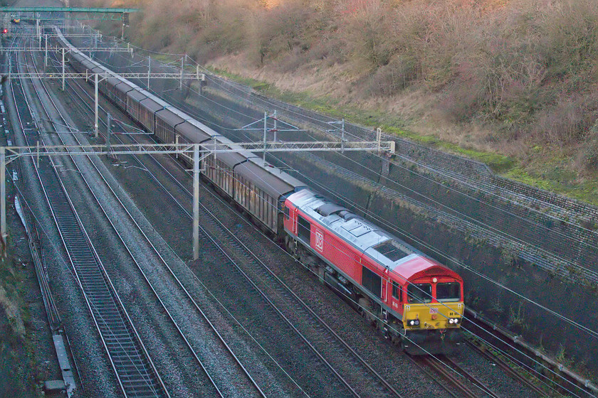 66165, 14.41 DIRFT-Dollands Moor (6O67, 1E), Roade cutting 
 The empty bottled water train passes south through Roade cutting led by DB liveried 66165. I was pleased that this particular Class 66 was leading this train as it was the first time that I have a photograph of it in this livery having many of it wearing its former EWS paint scheme. 
 Keywords: 66165, 14.41 DIRFT-Dollands Moor 6O67 Roade cutting DB Deutsche Bahn