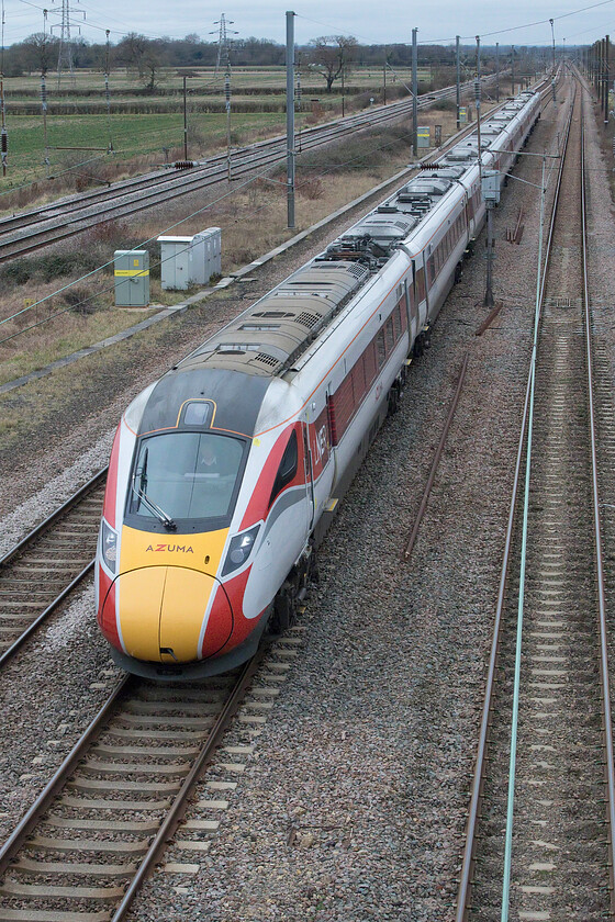 Class 800, GR 09.45 Leeds-London King's Cross (1A20, 4L), Marholm TF154036 
 An unidentified Class 800 Azuma approaches Peterborough from the north about to pass under Marholm's footbridge working the 1A20 09.45 Leeds to King's Cross service. Whilst this is a popular spot for railway photographers offering commanding views of the lines north and south, on a windy February day it is a pretty exposed spot and with me a little ill-prepared being somewhat under-dressed I felt it! Andy and I found shelter in his Nissan Micra between trains supping hot coffee from flasks! 
 Keywords: Class 800 GR 09.45 Leeds-London King's Cross 1A20 Marholm TF154036 LNER Azuma