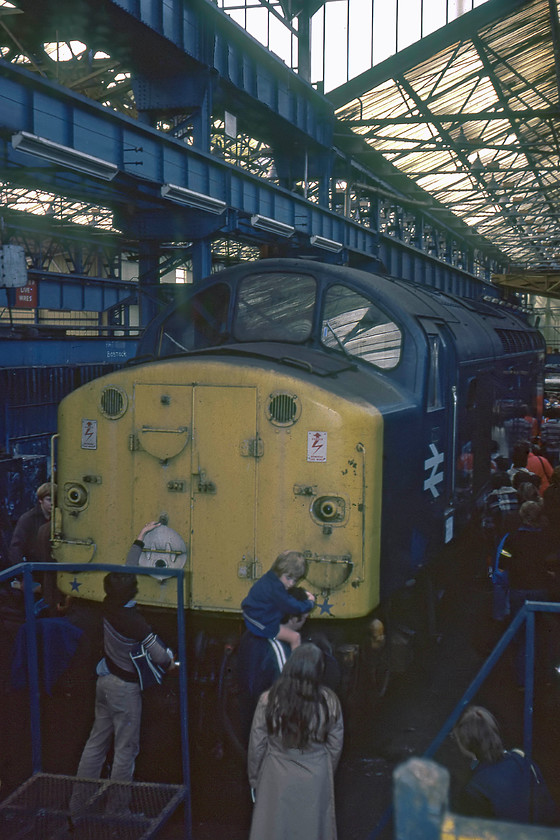 40079, undergoing overhaul Crewe Works 
 40079 is pictured in a busy Crewe Works surrounded by visitors. Notice the person attempting to alter the head code disc, curious as to how they are operated, I hope! 40079 was at the works for its final overhaul, which was completed in two months, being released into traffic during November. The locomotive then remained in use until withdrawal at Bescot in January 1985 as 'Life expired/surplus'. 
 Keywords: 40079 undergoing overhaul Crewe Works