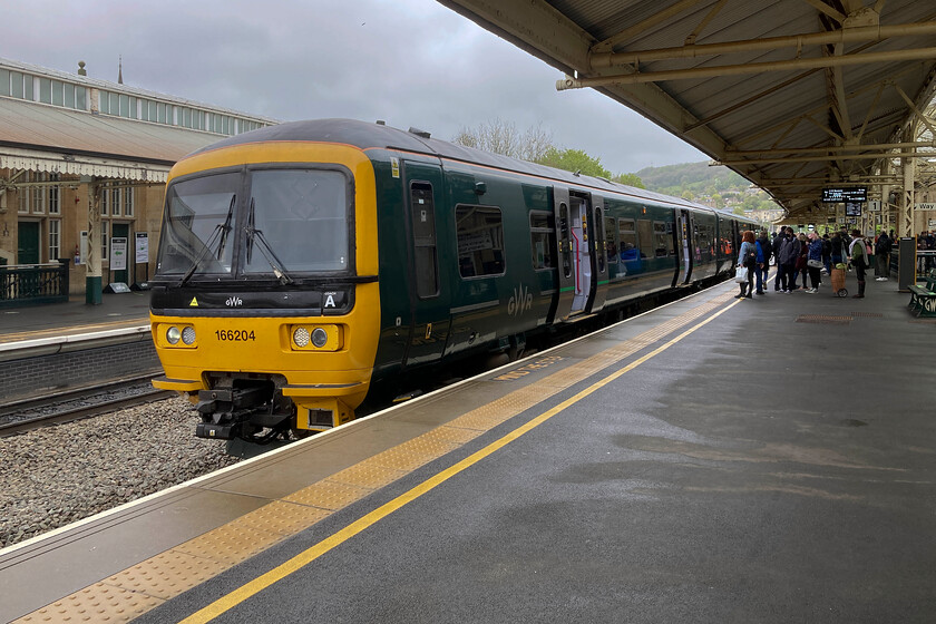 166204, GW 08.46 Weymouth-Gloucester (2V60, 2L), Bath Spa station 
 166204 pauses at Bath Spa station working the 08.46 Weymouth to Gloucester GWR service. My wife and I travelled on this train from Frome finding it busy but we felt perfectly 'covid safe'. This journey was unnecessarily slow due to a mysterious but timetabled twenty-minute dwell time at Westbury making the journey just under an hour. By road, all things being good, it should take half that time. It is things like this that will turn travellers away from the railways back to the roads. 
 Keywords: 166204 08.46 Weymouth-Gloucester 2V60 Bath Spa station GWR Great Western Railway Turbo