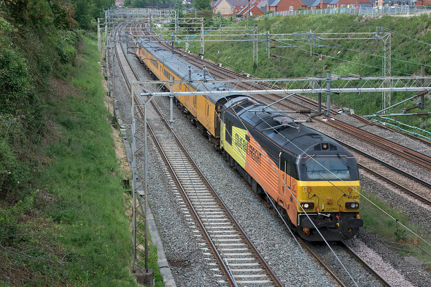 67027 & 67023, 12.29 Crewe CS-Derby RTC (1Q27, 30E), Ashton Road bridge 
 Running on the fast line the 12.29 Crewe to Derby Network Rail test train passes Roade. This working leaves Crewe just after lunchtime and after reversing at Euston returns to Crewe and is usually operated by the more familiar NMT HST, the archetypal 'Flying Banana'. After that, it runs via Kidsgrove to Stoke-on-Trent and thence Derby arriving in the early evening - in this particular case thirty minutes ahead of schedule. The train is top and tailed by Colas liveried 67027 'Charlotte' (front) and 67023 'Stella' (rear). 
 Keywords: 67027 67023 12.29 Crewe CS-Derby RTC 1Q27 Ashton Road bridge Network Rail test train Charlotte Stella