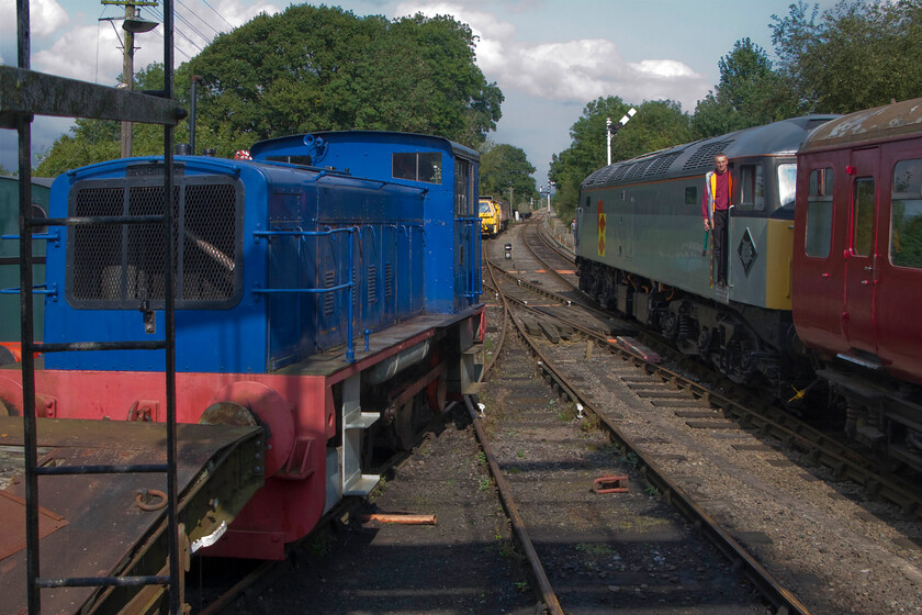 764 stabled & 47395, 12.00 Pitsford return, Pitsford station 
 The 12.00 Pitsford return Sunday working is seen waiting for the RA from the guard with the driver peering back around the curve that makes sighting tricky at the station. The Class 47 is their 'go-to' locomotive at the moment being the only one that is operational from their rather meagre fleet. To the left is 1953 built Ruston & Hornsby shunter 764 'Sir Gyles Isham' that I drove a few months previously as a Father's Day present, see..... https://www.ontheupfast.com/p/21936chg/C385149778/x31-father-s-day-to-nlr-15-06-14 
 Keywords: 764 47395 12.00 Pitsford return, Pitsford station Sir Gyles Isham